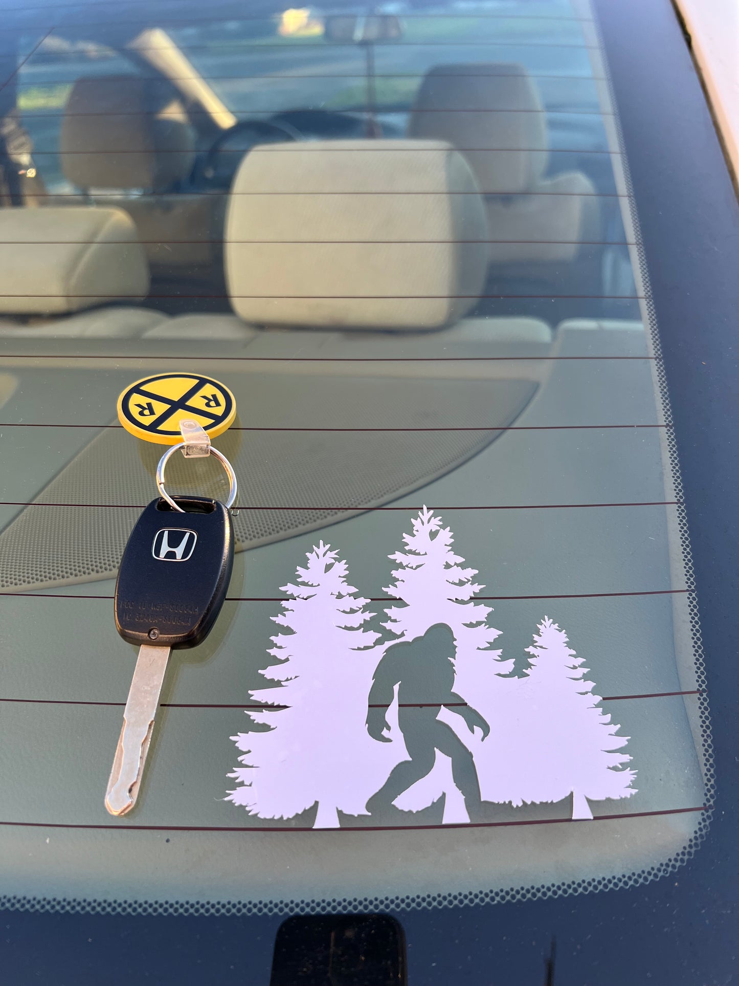 Black and  White vinyl cut stickes of Bigfoot and tree. The sticker is 4 inches by 4 inches.